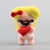 A yellow plush toy with a red bow and facial markings, holding a red heart.