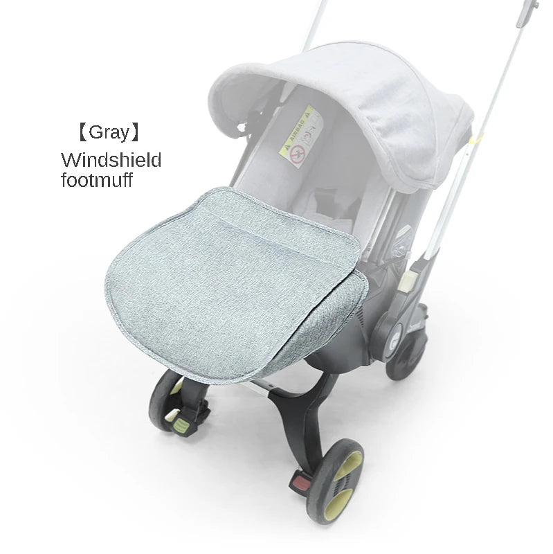 Gray windshield footmuff accessory for a stroller.