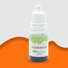 A small white dropper bottle containing green liquid for use as a food coloring agent.