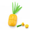 A yellow magnetic wooden pineapple toy with green leaves and a separate yellow fruit piece.