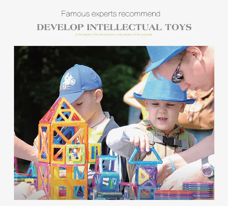 Two children build structures with colorful magnetic building tiles in a learning environment.