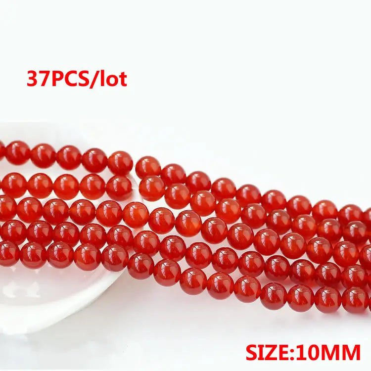 A string of 37 round, natural red carnelian beads, sized at 10mm, for jewelry making.