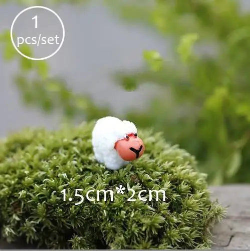A small white sheep figurine resting on a mossy green surface.