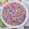 A bowl filled with multicolored heart-shaped fake candy sprinkles for slime and craft decorations
