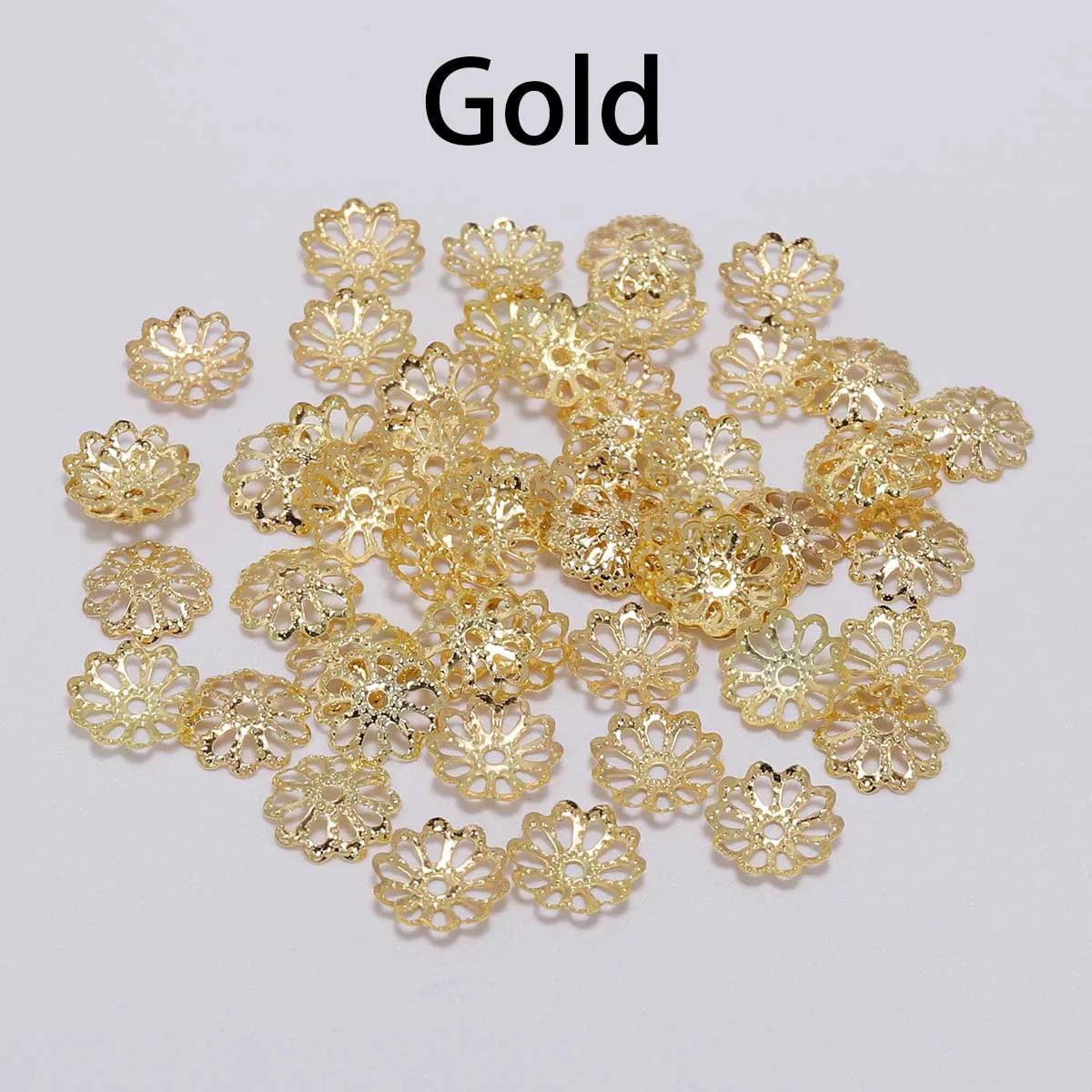 A collection of small, gold-colored flower petal bead caps for jewelry making.