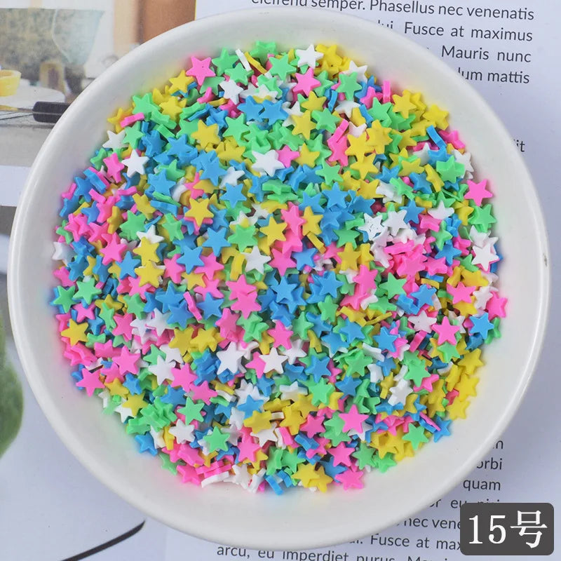 A bowl filled with heart-shaped fake candy sprinkles in various bright colors like pink, green, blue, and yellow for slime an