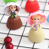 A set of two Transformable Scented Cupcake Princess dolls with pink and purple dresses and ruffled hair, displayed on a black