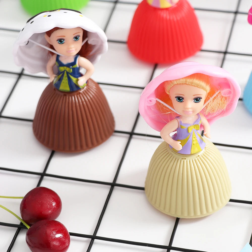 A set of two Transformable Scented Cupcake Princess dolls with pink and purple dresses and ruffled hair, displayed on a black