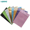 A collection of mini reusable ziplock bags in various colors including black, green, white, gold, blue, and purple.