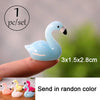 One set of light blue miniature swan figurines shown on a finger, with an option to send in random color.