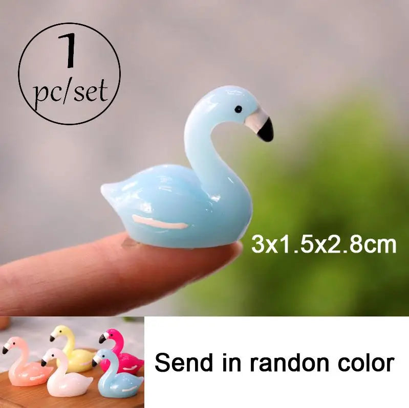 One set of light blue miniature swan figurines shown on a finger, with an option to send in random color.