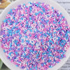 A bowl filled with heart-shaped fake candy sprinkles in various shades of pink and blue for slime and craft decorations.