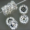 A collection of crystal rondelle spacer beads for jewelry making, showing various sizes and shapes.