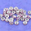 A collection of 100 crystal rondelle spacer beads in silver and pink stones for jewelry making