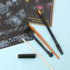 A set of scratch art tools including a brush, pencil, and a black marker on a light blue background.