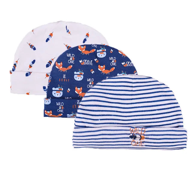 Three baby hats featuring cute cartoon wildlife designs in white, blue, and striped patterns.