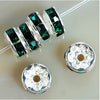 A string of green crystal rondelle spacer beads is displayed next to two silver jewelry findings.