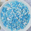 A bowl filled with heart-shaped fake candy sprinkles in blue and white for slime and craft decorations
