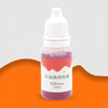 A small glass bottle containing pink liquid dye labeled for use in food or drink.