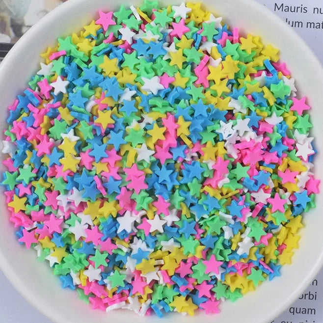 A bowl filled with heart-shaped fake candy sprinkles in various bright colors for slime and craft decorations