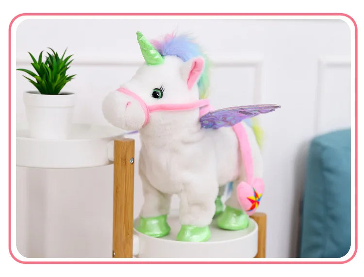 A white unicorn plush toy with pink accents and a green horn standing next to a potted plant.