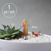 One set of miniature animal figurines for fairy gardens and terrariums, including a yellow and pink figure.