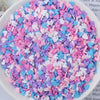 A bowl filled with heart-shaped fake candy sprinkles in various colors including pink, purple, blue, and white.