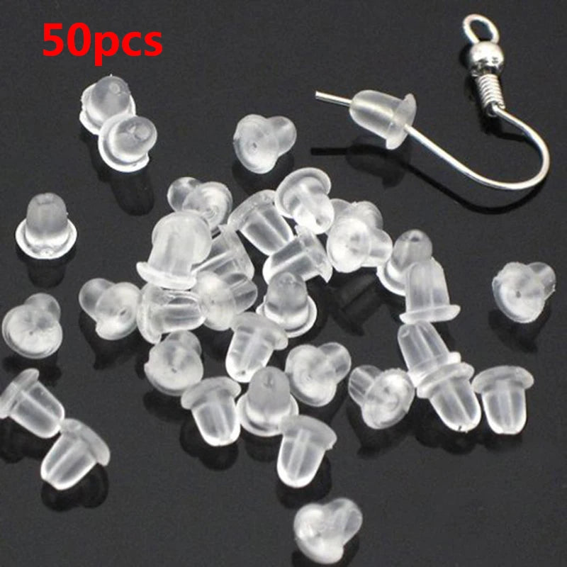A pile of 50 clear silicone earring backs and a single earring hook are displayed on a dark surface.