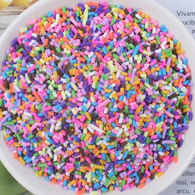 A bowl filled with multicolored heart-shaped fake candy sprinkles for slime and craft decorations
