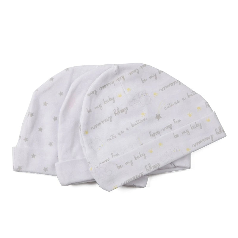 A stack of white baby hats featuring cute cartoon text like be my baby and sweet sleep