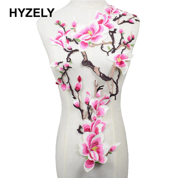 Pink and white plum blossom embroidery design on a mannequin torso.