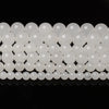 A row of natural white crystal quartz round beads for jewelry making