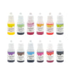 A row of twelve small bottles of liquid soap colorant dye in various colors and packaging.