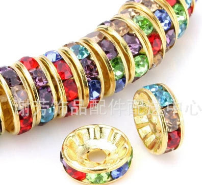 A close-up of a string of colorful crystal rondelle spacer beads for jewelry making
