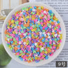 A bowl filled with multicolored heart-shaped fake candy sprinkles for slime and craft decorations