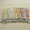 A collection of colorful lobster clasp keychains or charms arranged in a row on a light wooden surface.