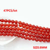 A string of small, round, natural red carnelian beads for jewelry making, with a size of 8mm.