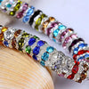 A close-up of a strand of colorful crystal rondelle spacer beads for jewelry making