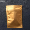 A small, gold-colored reusable ziplock bag is displayed against a dark blue textured background.