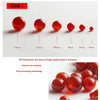A row of polished, round, translucent red carnelian beads of varying sizes are displayed on a white background.