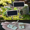 Two small wooden signs labeled A and B are shown on a hand, with a set of miniature animal figurines in a mossy garden settin