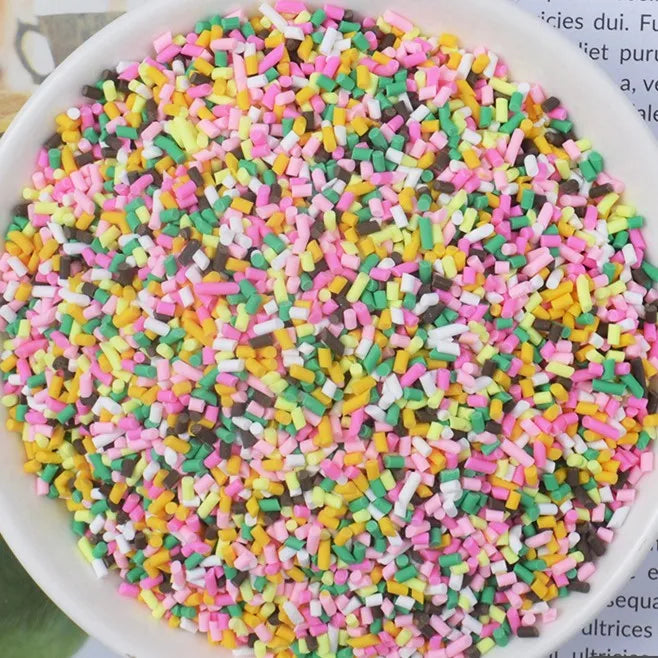 A bowl filled with multicolored heart-shaped fake candy sprinkles for slime and craft decorations