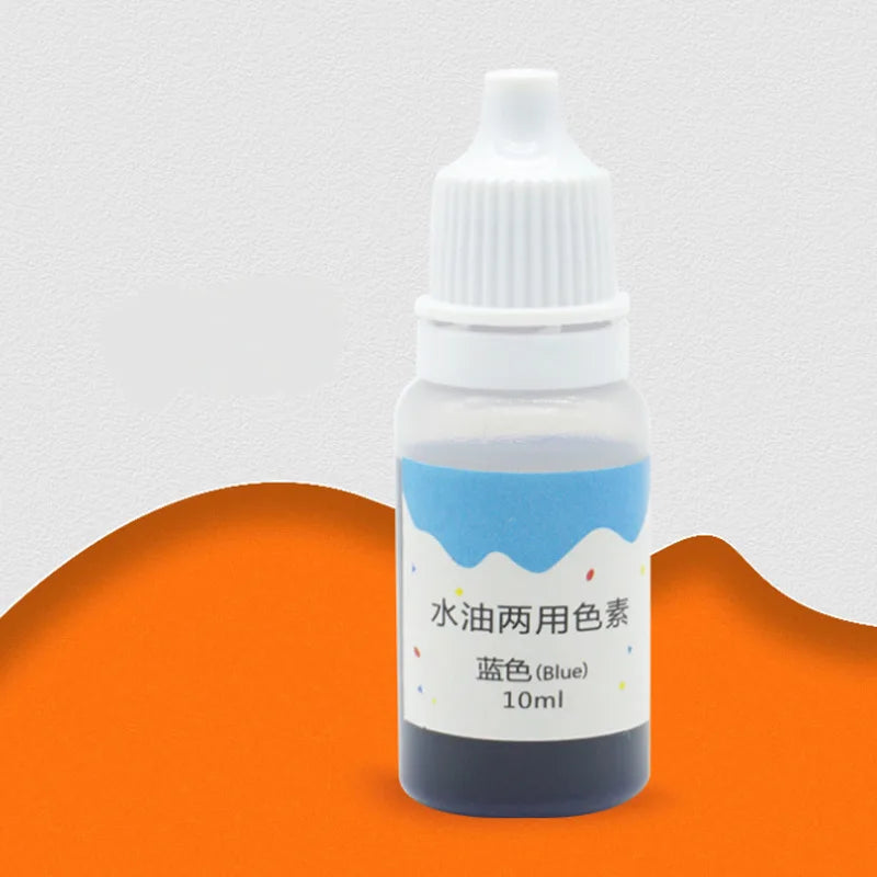 A small glass bottle of blue liquid colorant dye with a white dropper cap sitting on an orange surface.