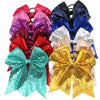 A collection of 12 glitter sequin pigtail bows in various colors including pink, purple, red, blue, and gold.