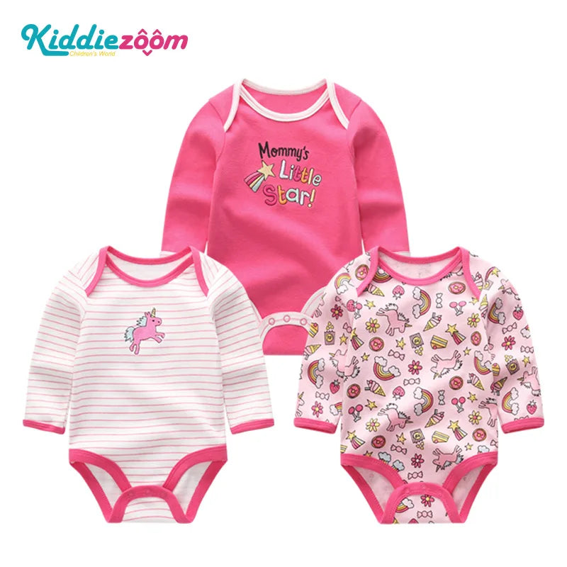A set of three pink cotton baby bodysuits with long sleeves featuring different patterns and designs.