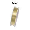 A spool of gold beading wire used for jewelry making.