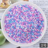 A bowl filled with heart-shaped fake candy sprinkles in various shades of pink and blue for slime and craft decorations