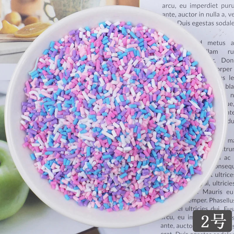 A bowl filled with heart-shaped fake candy sprinkles in various shades of pink and blue for slime and craft decorations