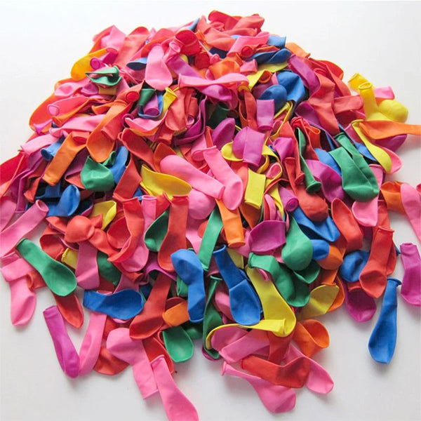 A pile of brightly colored, thin latex air balloons in various shades of pink, orange, blue, and green.