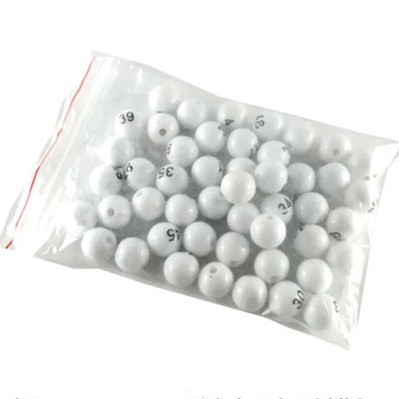A clear plastic bag filled with white numbered balls for bingo and lottery games